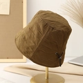 Quilted dark brown bucket hat with adjustable drawstring on a minimalist metal display stand - M (56-58cm) / Coffee