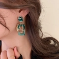 Deep green marble resin drop earrings with gold wire wrap on model for a retro look - Green Marble Geometric Square Earrings