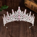 Close-up of bridal crown featuring pink crystals and rhinestones on dark wood - Silver with Pink Rhinestone