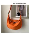 Orange nylon half-moon crossbody bag with a playful black soot sprite plush charm - Soot Sprite Charm Style / Orange