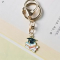 Golden graduation keychain with mini mortarboard, stacked books, and diploma scroll - Style 3 (Lobster Clasp)