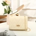 Elegant cream white quilted chain bag with gold rotary lock and triangular stitching - Off White