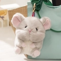 Cute gray plush mouse bag charm with pink ears hanging on a canvas backpack - Mouse