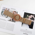 Close-up of woven straw belt with a large round wooden buckle on a magazine - Round Buckle Khaki