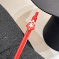 Red Christmas retractable gel pen featuring a festive bell charm with snowflake patterns - Snowflake Bell
