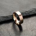 Polished 6mm rose gold stainless steel ring for couples on dark stone background. - 6 / 6mm / Rose Gold