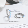 Minimalist silver hoop earrings featuring five round blue opal stones for a luxury look - White Gold