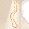 Detail of gold wheat chain necklace with lobster clasp on artistic background - A0158 Wheat Link Chain