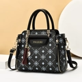 Sac à main noir à motifs élégants avec détails dorés et pendentif à pompon décoratif - Noir