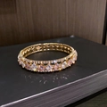 Macro-opname van de gouden dubbellaagse armband met roze en witte vierkante kristallen - Verstelbaar Open / Roze Stijl 2