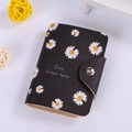 Black PU leather card holder with daisy patterns and metal snap closure - Daisy Black