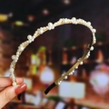 Close-up of white pearls on golden metal frame with anti-slip cover on a hairband - S271-1 Pearl Wave Arrangement Style