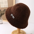 Detailed view of brown faux lamb wool bucket hat with decorative side tag and button - Coffee