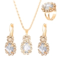 Close-up of gold jewelry set with large oval crystals and sparkling halo of small gems - Oval KC Gold White Style (2766)