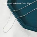 Silver embossed snake chain necklace with textured details on a blue ceramic plate - 45 cm / Embossed Snake Chain (Silver)
