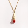 Close-up of a punk-style microphone pendant in gold and red finish on a steel chain - Red