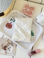 White quilted bow makeup pouch with pearl keychain strap on an aesthetic display tray - White (With Charm)