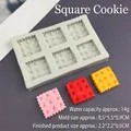 Macro detail of 6-cavity square biscuit silicone mold with textured waffle samples - Square Cookie / Gray