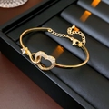 Detailed view of gold heart and infinity bracelet with sparkling zircon in a gift box - Gold