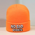 Detailed view of NO BAD VIBES black and white embroidery on orange knit beanie hat - One Size / Orange