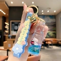 Blue liquid quicksand keychain with white rabbit charm and silicone wrist strap - Soda Bottle