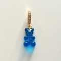 Detail of a translucent blue resin gummy bear pendant with a gold zircon-set clasp - Transparent Royal Blue
