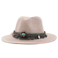 Close-up of pink woven straw sun hat with turquoise bead and bohemian fringe details - Nude Pink