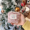 Mini pink floral cosmetic pouch with embroidery on a festive Christmas background - Embossed Plum Pink