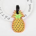 Vibrant pineapple-shaped silicone luggage tag with yellow base and black strap - Polka Dot Pineapple