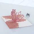 Detail of laser cut 3D wedding invitation with Mr & Mrs silhouette and glitter accents - Glitter Pink