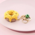 Handmade crochet donut keychain in yellow and brown with gold ring and green bell - Donut-Yellow