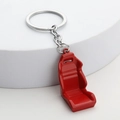Red racing seat car keychain made of durable metal with silver key ring on white background - Red