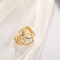 Irregular geometric gold stainless steel ring with hollow design on white silk fabric - 18K Gold Plated Criss Cross Wrap