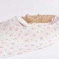 Bamboo cotton muslin baby swaddle blanket with pink pig print draped over a basket - Little Pink Pig