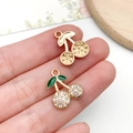 Golden cherry pendant with sparkling white rhinestones and green leaf for DIY jewelry - KC Gold White Enamel White Rhinestone Cherry (23403)
