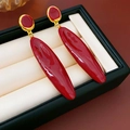 Deep red enamel leaf drop earrings with gold-toned metal base on jewelry cushion - Red Enamel Oval Water Drop Dangle Earrings