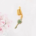 Detail of vintage gold spring coil featuring a bronze flower-patterned key charm pendant - Key Style