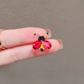 Compact ladybug brooch with red gems and gold finish displayed on a finger - 447# Red Bee