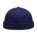 Detail view of a navy blue docker cap with rolled brim and top button on a white background - Adjustable / Navy Blue