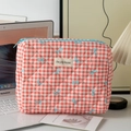 Close-up of quilted red and white gingham makeup bag with blue ribbon prints and zip - Medium Cosmetic Bag