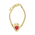 Detail of gold mesh bracelet featuring a red heart pendant with zircon accents - Brown