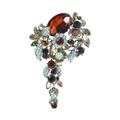 Macro detail of retro flower brooch with blue crystals and large brown gemstone - Flower Shape / Sea Green