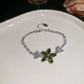 Détail macro du bracelet fleur en zircon vert avec chaîne en argent ajustable - 42# Bracelet fleur en zircone vert de ton argent