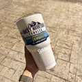 Close-up of 30oz white stainless steel tumbler with 24h cold insulation held by hand - Single Cup + Stainless Steel Straw / Textured White
