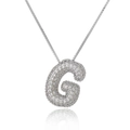 Macro shot of silver letter G pendant with micro-paved cubic zirconia on box chain - Letter G