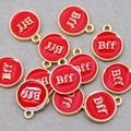 Macro detail of red and gold BFF circular enamel charms for DIY jewelry making - Red