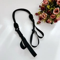 Macro shot of durable black nylon grooming leash with high-strength adjustable plastic buckle - Solid Black Shoulder Strap