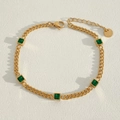 Macro shot of gold-plated stainless steel chain bracelet with five square green stones - Green Gem Cuban Style (K469)