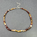 Detailed macro view of bohemian irregular natural stone chips necklace with lobster clasp - Yellow Jasper
