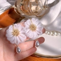 Close-up of handmade white crochet flower earrings with gold plating and pearl drops - White Woven Flower Pearl Dangle